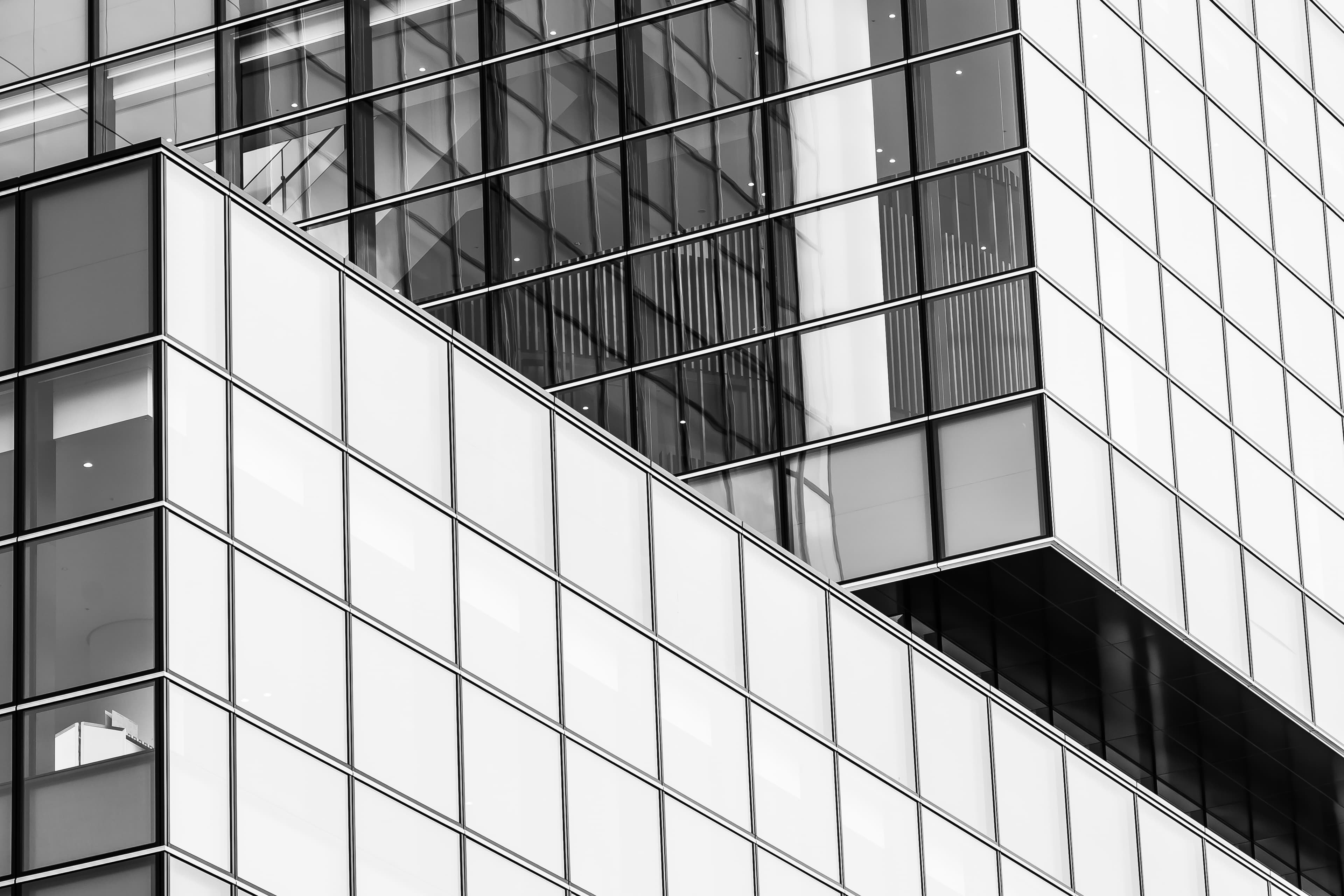 Black and white photograph of a modern glass office building facade